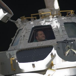 STS 130 Nicholas Patrick looks through Cupola